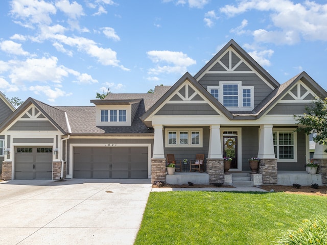 1621 Dutch Lake Dr, Minnetrista, MN 55364 - craftsman house featuring stone siding, roof with shingles, a porch, an attached garage, and driveway