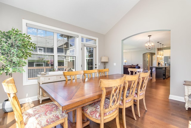 1621 Dutch Lake Dr, Minnetrista, MN 55364 - dining area with arched walkways, dark wood-style flooring, a chandelier, and high vaulted ceiling