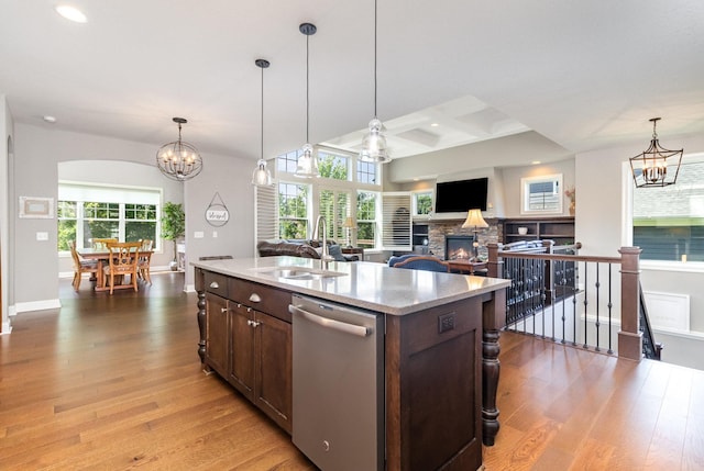 1621 Dutch Lake Dr, Minnetrista, MN 55364 - kitchen featuring dishwasher, a chandelier, a stone fireplace, dark brown cabinets, and light wood-type flooring