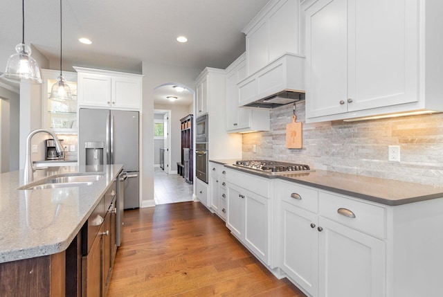 1621 Dutch Lake Dr, Minnetrista, MN 55364 - kitchen featuring appliances with stainless steel finishes, arched walkways, white cabinets, recessed lighting, and decorative light fixtures