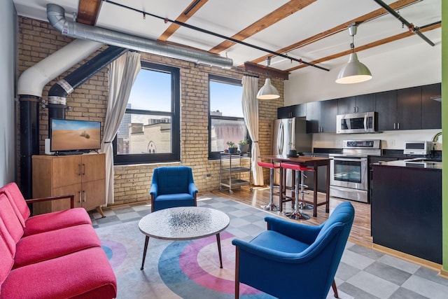 406 Wacouta St Unit 611, Saint Paul, MN 55101 - living room featuring brick wall, light flooring, and a high ceiling