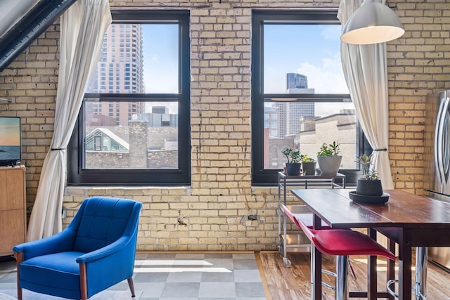 406 Wacouta St Unit 611, Saint Paul, MN 55101 - dining room with a city view, brick wall, and tile patterned floors