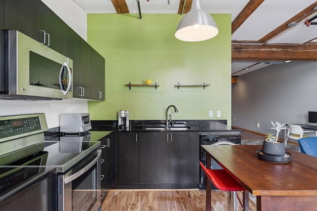 406 Wacouta St Unit 611, Saint Paul, MN 55101 - kitchen with stainless steel appliances, light wood finished floors, dark cabinets, and beam ceiling