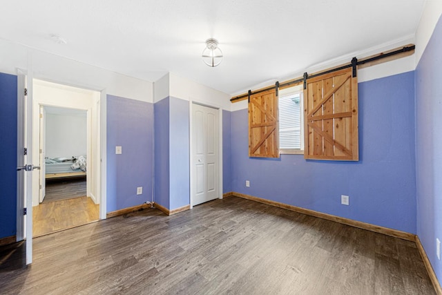2115 Turpin St, Saint Peter, MN 56082 - unfurnished bedroom with wood finished floors, a barn door, and a closet