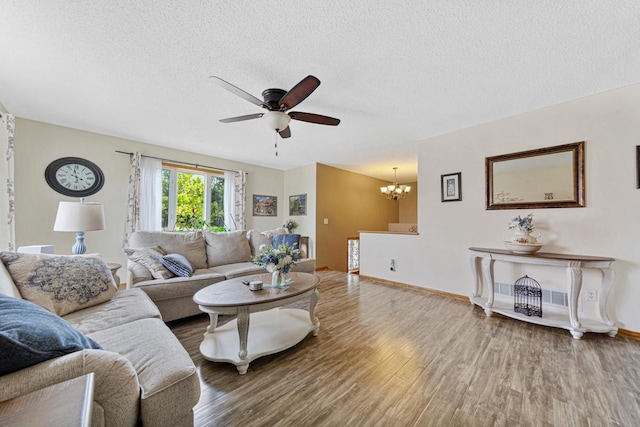 2115 Turpin St, Saint Peter, MN 56082 - living room featuring a chandelier, wood finished floors, ceiling fan, and a textured ceiling