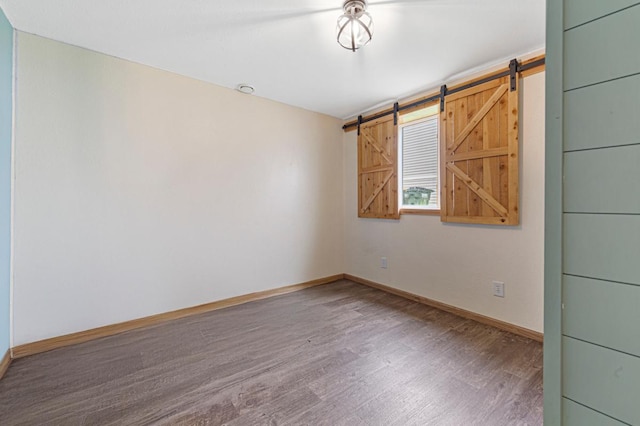 2115 Turpin St, Saint Peter, MN 56082 - unfurnished room featuring wood finished floors and a barn door