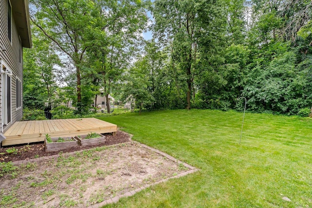 5245 Dufferin Dr, Savage, MN 55378 - view of green lawn featuring a wooden deck and view of wooded area