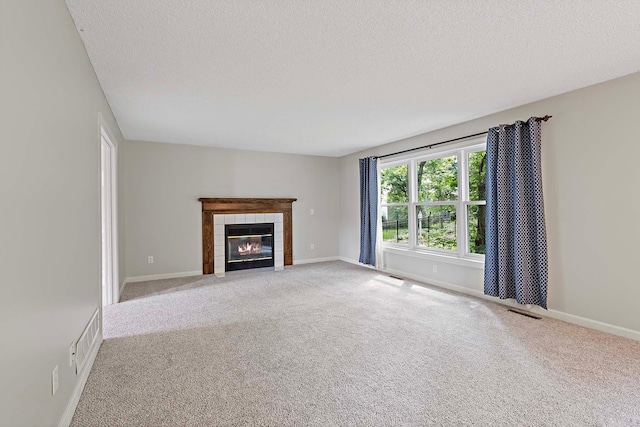 5245 Dufferin Dr, Savage, MN 55378 - unfurnished living room featuring a textured ceiling, a tiled fireplace, and carpet floors