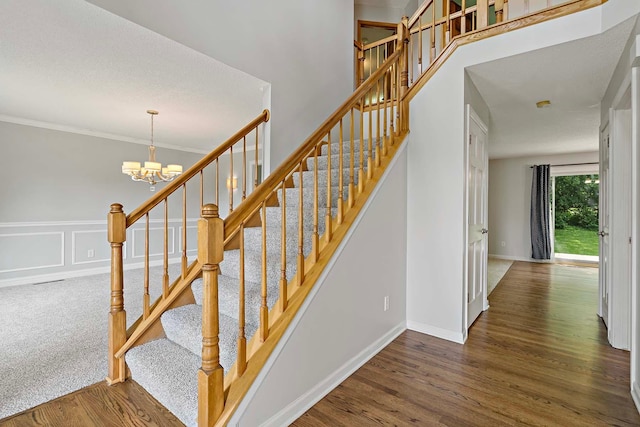 5245 Dufferin Dr, Savage, MN 55378 - stairs featuring wood finished floors, a chandelier, ornamental molding, a decorative wall, and wainscoting