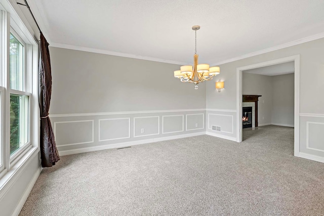 5245 Dufferin Dr, Savage, MN 55378 - unfurnished room featuring a chandelier, carpet flooring, crown molding, a decorative wall, and wainscoting