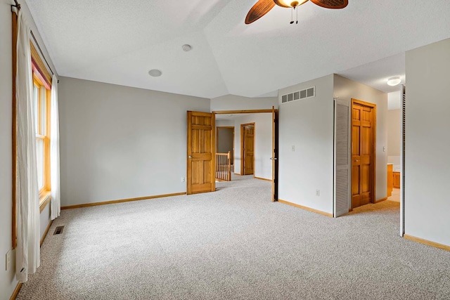 5245 Dufferin Dr, Savage, MN 55378 - unfurnished bedroom featuring carpet, a closet, vaulted ceiling, ceiling fan, and a textured ceiling