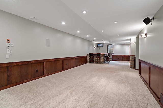 5245 Dufferin Dr, Savage, MN 55378 - below grade area featuring a wainscoted wall, bar area, light carpet, and recessed lighting