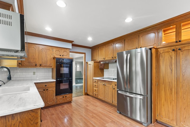 6325 Brookview Ave, Edina, MN 55424 - kitchen featuring black appliances, ornamental molding, backsplash, light wood-style floors, and brown cabinets