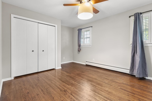 6325 Brookview Ave, Edina, MN 55424 - unfurnished bedroom featuring a baseboard heating unit, wood finished floors, a closet, and a ceiling fan