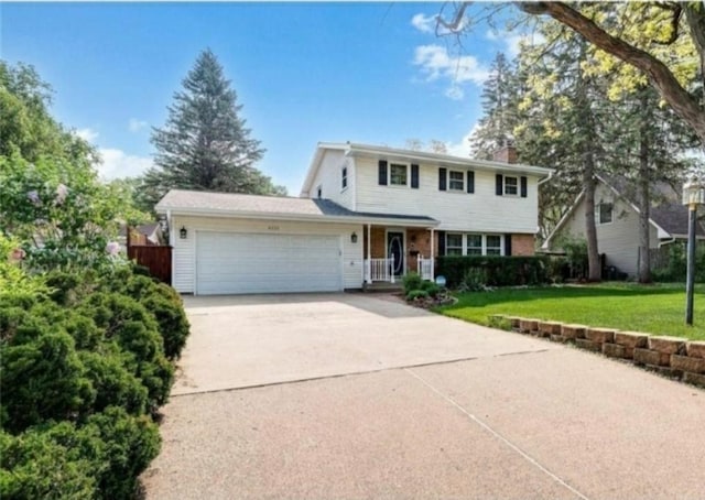 6325 Brookview Ave, Edina, MN 55424 - traditional-style home with a front yard, an attached garage, driveway, a chimney, and a porch