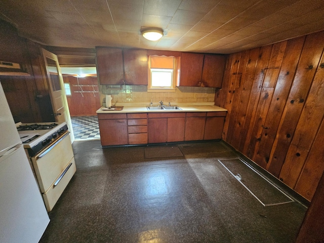 1624 24th Ave SE, Rochester, MN 55904 - kitchen with white range with gas stovetop, wood walls, extractor fan, light countertops, and dark flooring