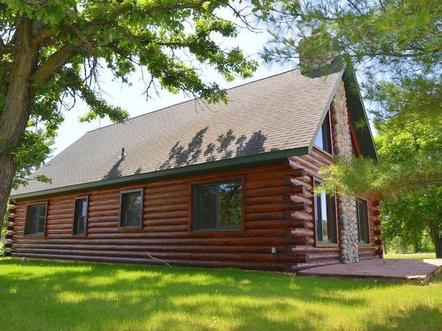 17771 State 34, Park Rapids, MN 56470 - view of home's exterior with log siding, a chimney, roof with shingles, and a yard