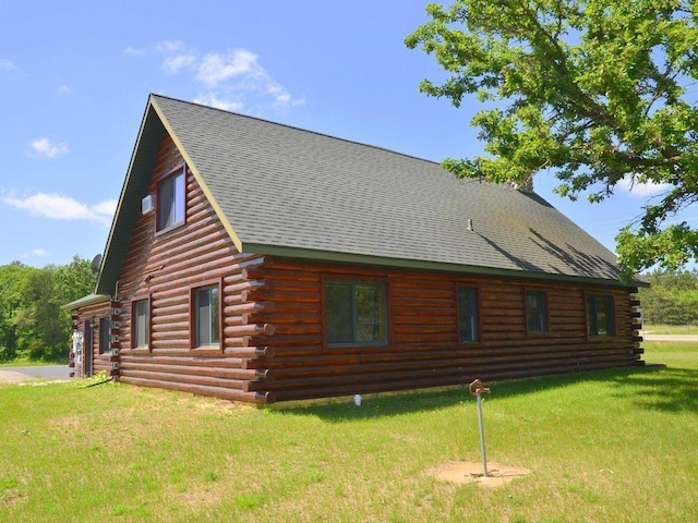 17771 State 34, Park Rapids, MN 56470 - view of side of property with log exterior, a yard, and roof with shingles