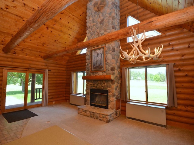 17771 State 34, Park Rapids, MN 56470 - unfurnished living room featuring a chandelier, carpet floors, high vaulted ceiling, a fireplace, and rustic walls
