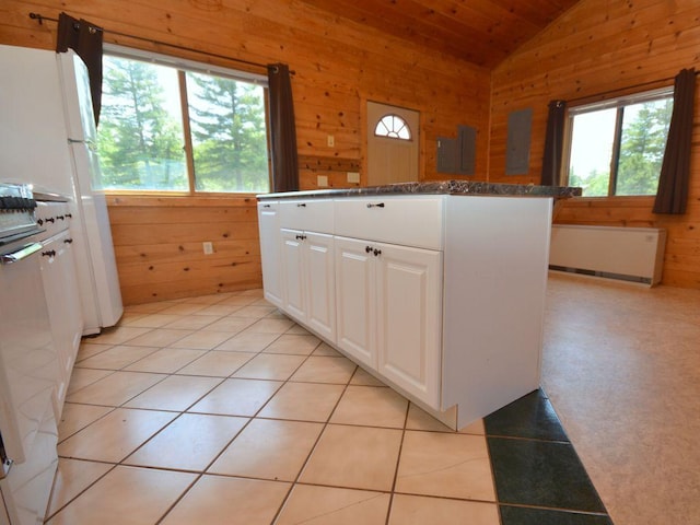 17771 State 34, Park Rapids, MN 56470 - kitchen featuring radiator, vaulted ceiling, healthy amount of natural light, wooden walls, and white cabinetry