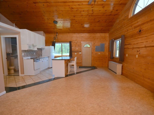 17771 State 34, Park Rapids, MN 56470 - kitchen with white appliances, wood walls, white cabinets, a kitchen breakfast bar, and wooden ceiling
