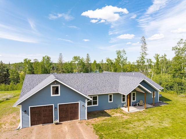 4335 Spring View Dr, Moose Lake, MN 55767 - view of front facade featuring a front lawn, a garage, driveway, and roof with shingles