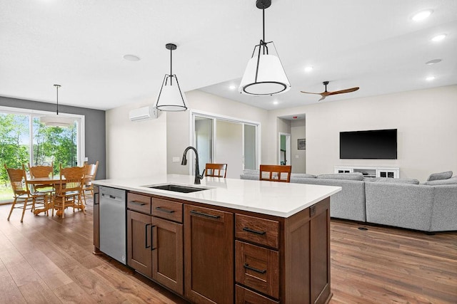4335 Spring View Dr, Moose Lake, MN 55767 - kitchen featuring stainless steel dishwasher, wood finished floors, light countertops, a wall unit AC, and recessed lighting