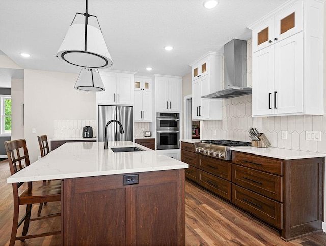 4335 Spring View Dr, Moose Lake, MN 55767 - kitchen featuring wall chimney exhaust hood, appliances with stainless steel finishes, dark wood-type flooring, backsplash, and recessed lighting