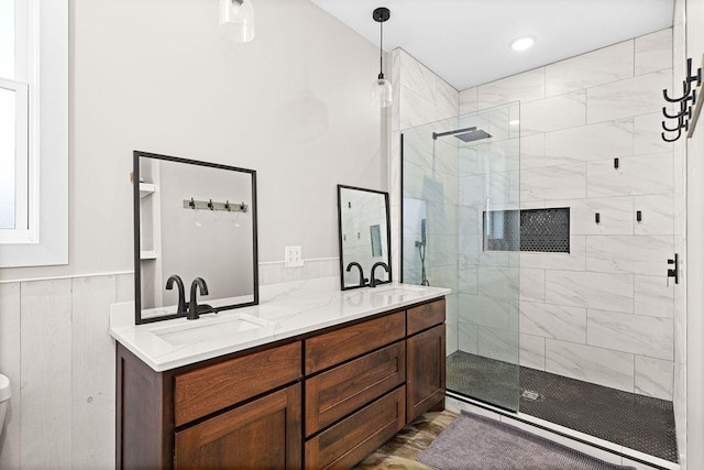 4335 Spring View Dr, Moose Lake, MN 55767 - bathroom featuring tiled shower, double vanity, and wainscoting