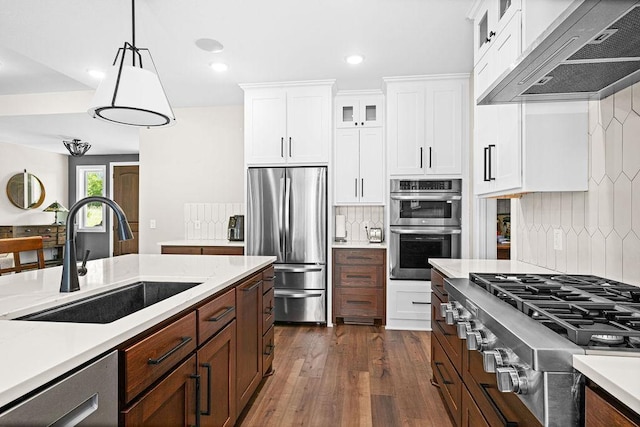 4335 Spring View Dr, Moose Lake, MN 55767 - kitchen with range hood, stainless steel appliances, backsplash, dark wood-type flooring, and recessed lighting