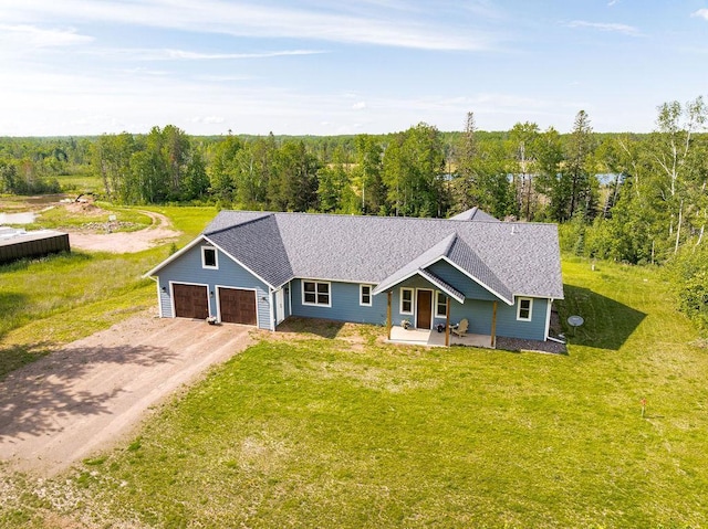 4335 Spring View Dr, Moose Lake, MN 55767 - single story home with dirt driveway, a forest view, a front lawn, and an attached garage
