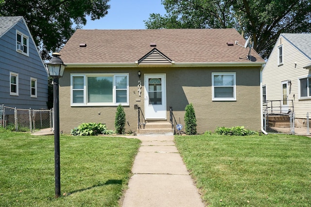 5041 Upton Ave N, Minneapolis, MN 55430 - bungalow-style house featuring stucco siding, entry steps, roof with shingles, and a gate