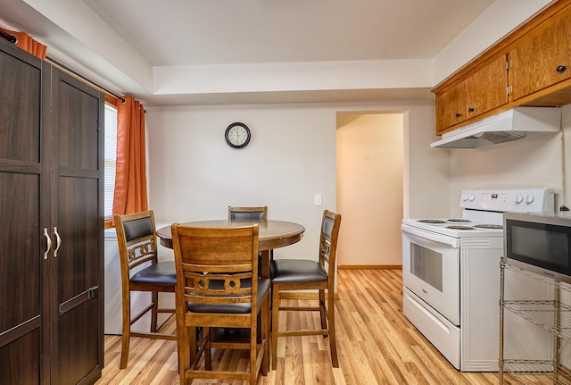 5041 Upton Ave N, Minneapolis, MN 55430 - kitchen with white range with electric cooktop, under cabinet range hood, stainless steel microwave, and light wood-type flooring