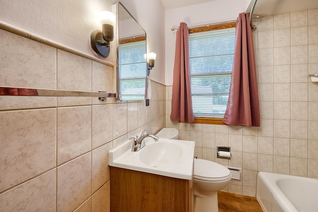 5041 Upton Ave N, Minneapolis, MN 55430 - bathroom featuring tile walls, vanity, and a bathtub