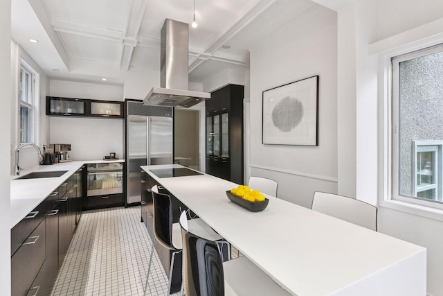 4626 Dupont Ave S, Minneapolis, MN 55419 - kitchen with black appliances, island exhaust hood, light countertops, coffered ceiling, and healthy amount of natural light