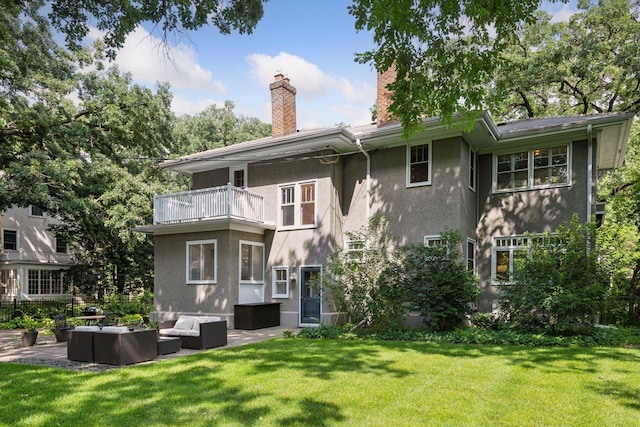 4626 Dupont Ave S, Minneapolis, MN 55419 - back of house featuring a balcony, an outdoor hangout area, stucco siding, a yard, and a chimney