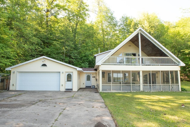 42674 305th Pl, Aitkin, MN 56431 - view of front of home featuring a sunroom, a front lawn, a balcony, and driveway