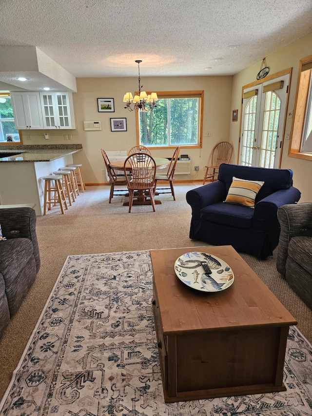 42674 305th Pl, Aitkin, MN 56431 - carpeted living room with a textured ceiling, a chandelier, and recessed lighting