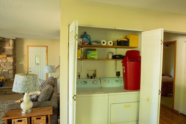 42674 305th Pl, Aitkin, MN 56431 - washroom featuring separate washer and dryer, a textured ceiling, and dark wood-style flooring