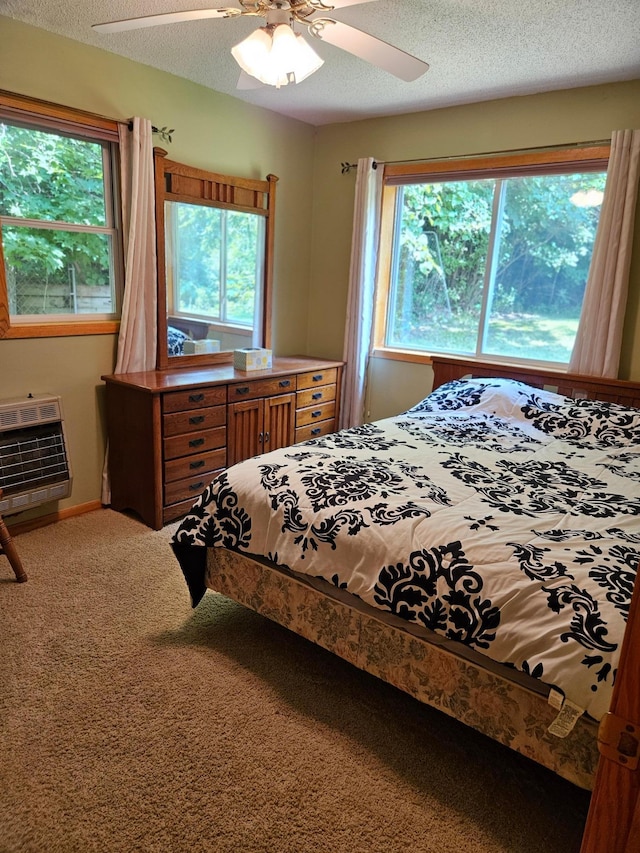 42674 305th Pl, Aitkin, MN 56431 - carpeted bedroom featuring heating unit, multiple windows, a textured ceiling, and a ceiling fan