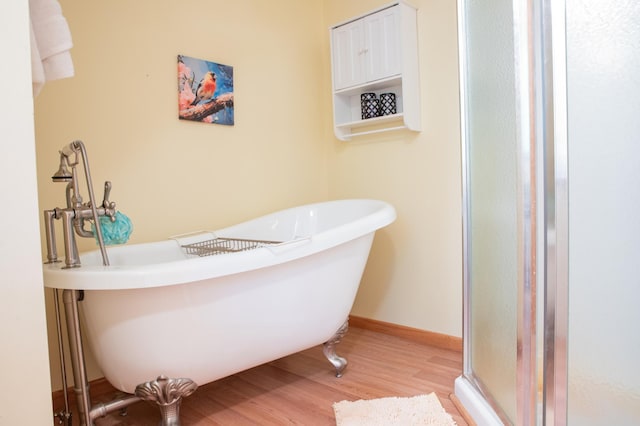 42674 305th Pl, Aitkin, MN 56431 - full bath with wood finished floors, a freestanding tub, and a stall shower