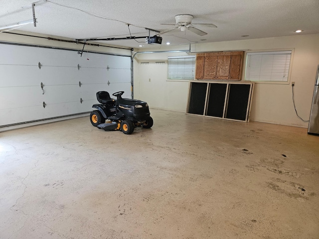 42674 305th Pl, Aitkin, MN 56431 - garage with a garage door opener, freestanding refrigerator, and ceiling fan