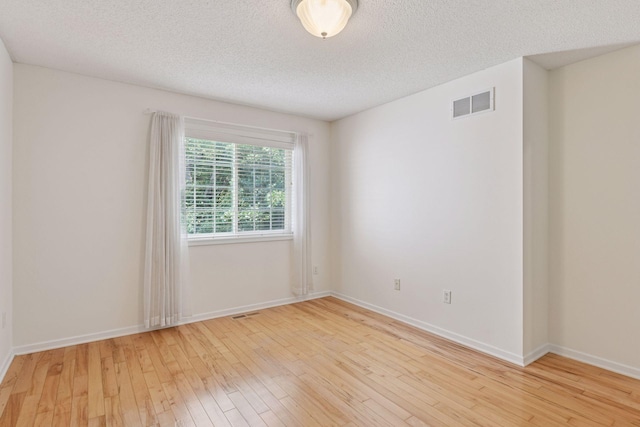 913 Carriage Ln, Chaska, MN 55318 - empty room featuring hardwood / wood-style floors and a textured ceiling
