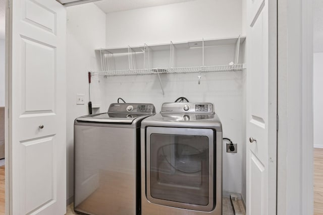 913 Carriage Ln, Chaska, MN 55318 - laundry room featuring washing machine and dryer and light wood-style floors