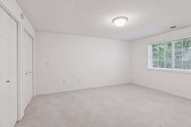 913 Carriage Ln, Chaska, MN 55318 - unfurnished bedroom with a textured ceiling and light carpet