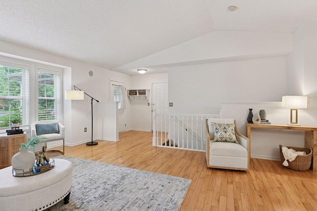 913 Carriage Ln, Chaska, MN 55318 - sitting room with an upstairs landing, lofted ceiling, and wood-type flooring