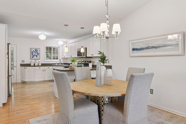 913 Carriage Ln, Chaska, MN 55318 - dining room featuring a chandelier and light wood-type flooring