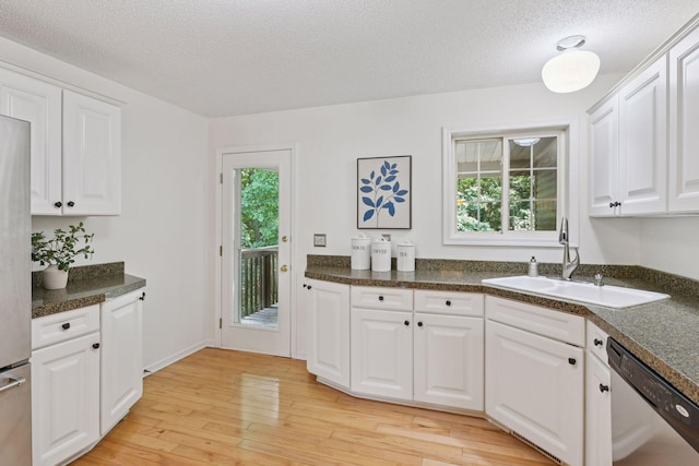 913 Carriage Ln, Chaska, MN 55318 - kitchen with dishwasher, white cabinets, dark countertops, light wood-type flooring, and a textured ceiling
