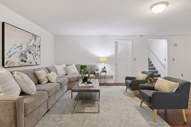 913 Carriage Ln, Chaska, MN 55318 - living room featuring stairs, wood finished floors, and a textured ceiling