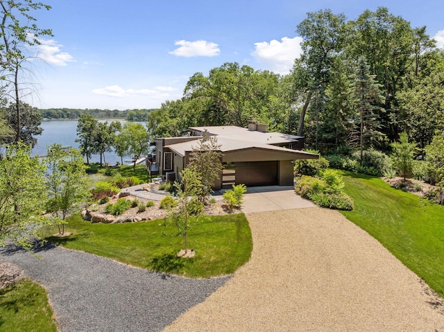 5962 Hobe Ln, White Bear Twp, MN 55110 - mid-century modern home featuring concrete driveway, a water view, stucco siding, a front yard, and a carport